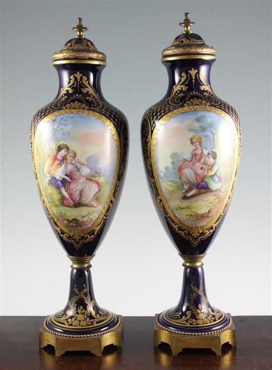 A pair of Sevres style gilt metal mounted urns, first half 20th century, 46cm